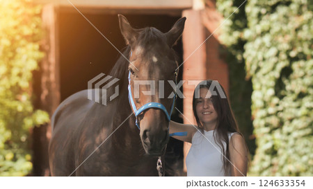 Young girl with a beloved horse on a summer day. 124633354