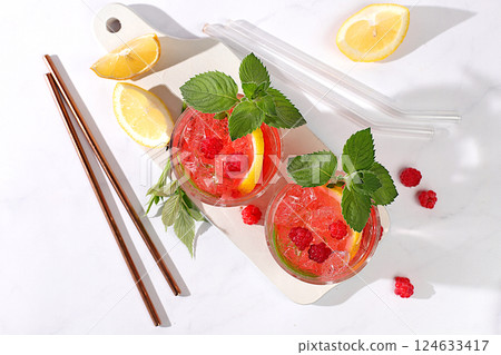 Refreshing summer homemade lemonade cocktail, mojito with raspberry, currant, mint and lemon, weight loss concept, detox water with fruit flavor on light background. healthy and natural food, Refreshing summer homemade lemonade cocktail, mojito with raspberry, currant, mint and lemon, weight loss concept, detox water with fruit flavor on light background. healthy and natural food, 124633417