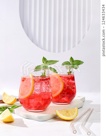 Refreshing summer homemade lemonade cocktail, mojito with raspberry, currant, mint and lemon, weight loss concept, detox water with fruit flavor on light background. healthy and natural food Refreshing summer homemade lemonade cocktail, mojito with raspberry, currant, mint and lemon, weight loss concept, detox water with fruit flavor on light background. healthy and natural food 124633434