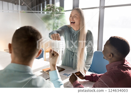 Joyful Caucasian businesswoman express unity, sharing fist bump with colleague 124634003