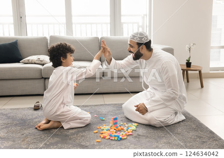 Arabian father and little son giving high-five gesture 124634042