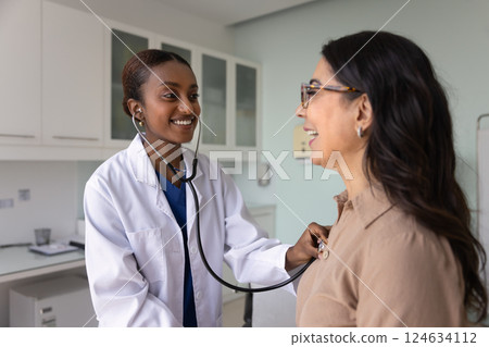 Happy young African American therapist woman checking heartbeat rate 124634112