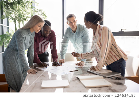 Young diverse teammates engaged in brainstorming, decision-making during meeting Young diverse teammates engaged in brainstorming, decision-making during meeting 124634185