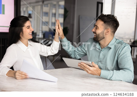 Cheerful Latin business project partners giving high five Cheerful Latin business project partners giving high five 124634188