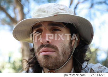 Sad Serviceman Sitting On The Ground In The Countryside Reflects On Memorial Day 124634226