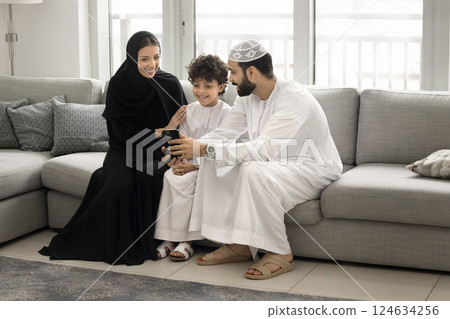 Arabic family with little son using modern smartphone at home Arabic family with little son using modern smartphone at home 124634256