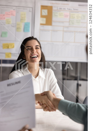 Cheerful Hispanic young applicant woman getting hired 124634352