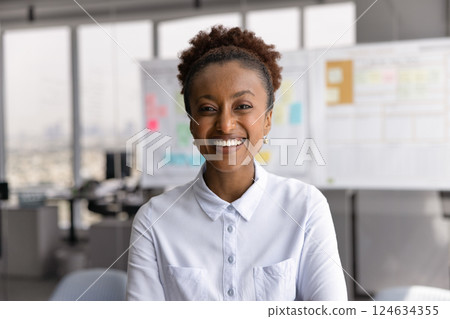 Happy successful beautiful African American businesswoman posing for head shot 124634355