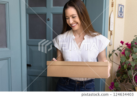 Woman holding package feel excited of receiving long-awaited order 124634403