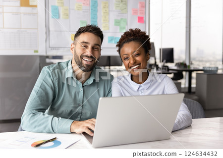 Happy young diverse business partners posing for portrait in office Happy young diverse business partners posing for portrait in office 124634432