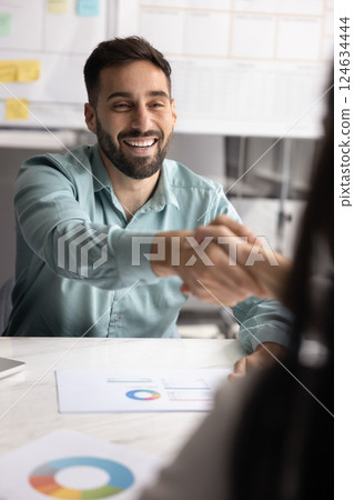 Happy Latin project leader man shaking hands with business colleague 124634444