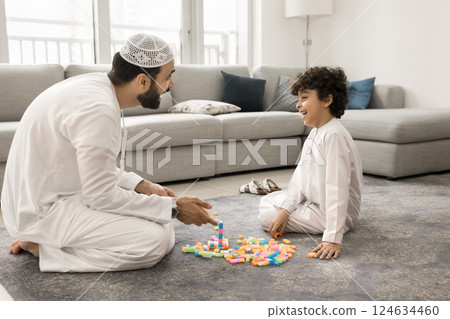 Arabic man playing colorful blocks with little son 124634460