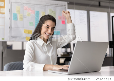 Cheerful excited successful Hispanic manager woman enjoying business success 124634543