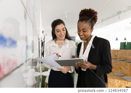 Positive young diverse office friends working on project together 124634567