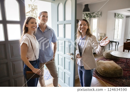 Agent welcoming married couple into house for sale or renting Agent welcoming married couple into house for sale or renting 124634590