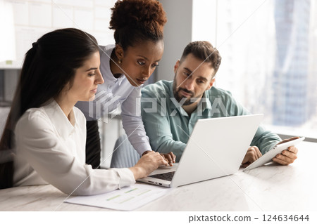 Diverse team of business colleagues analyzing sales financial report Diverse team of business colleagues analyzing sales financial report 124634644