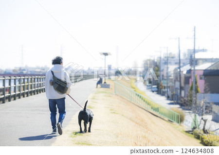 Man walking a dog Man walking a dog 124634808