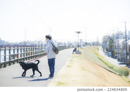 Man walking a dog 124634809