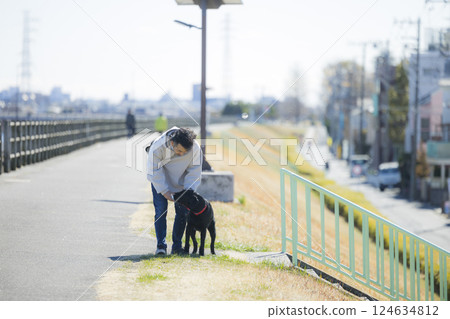 Man walking a dog Man walking a dog 124634812