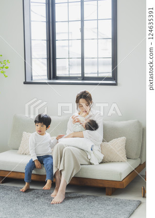 A family relaxing in the living room A family relaxing in the living room 124635391