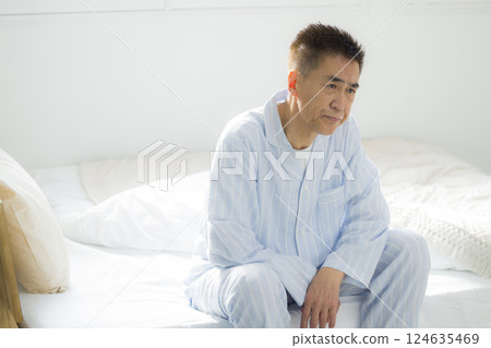 Senior man in bed feeling unwell 124635469