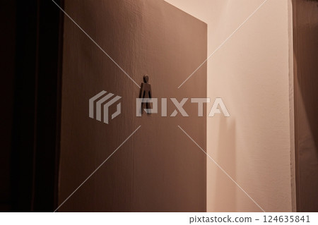 Toilet door left ajar, men's toilet sign 124635841