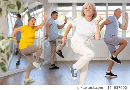 Group of aged people rehearsing sports dance in dance class Group of aged people rehearsing sports dance in dance class 124637600