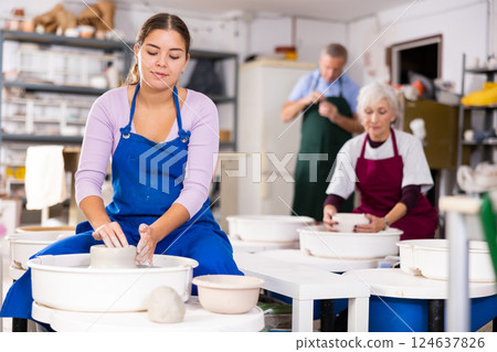 girl works with potter wheel girl works with potter wheel 124637826