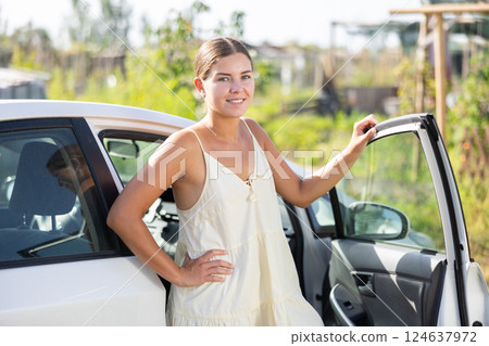 Portrait of smiling girl about to get into her car 124637972