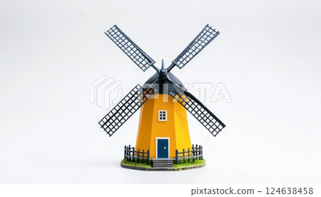 Miniature yellow windmill against a white backdrop. This image could illustrate travel, farming, or traditional architecture. 124638458
