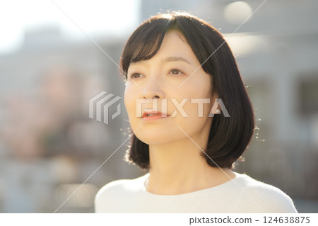 A middle-career woman enjoying the fresh air 124638875