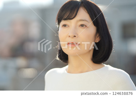 A middle-career woman enjoying the fresh air 124638876