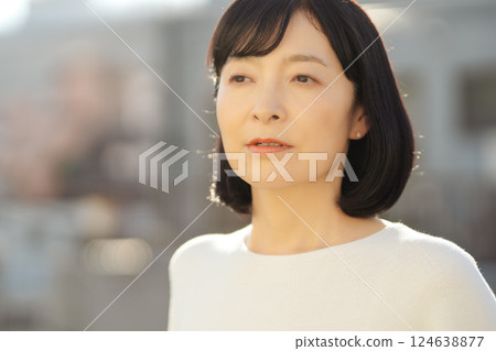 A middle-career woman enjoying the fresh air 124638877