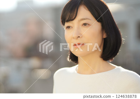 A middle-career woman enjoying the fresh air 124638878