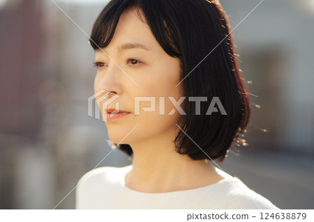 A middle-career woman enjoying the fresh air 124638879
