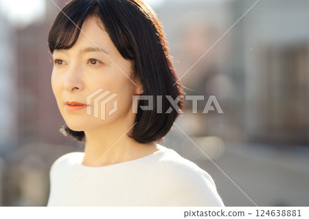 A middle-career woman enjoying the fresh air 124638881