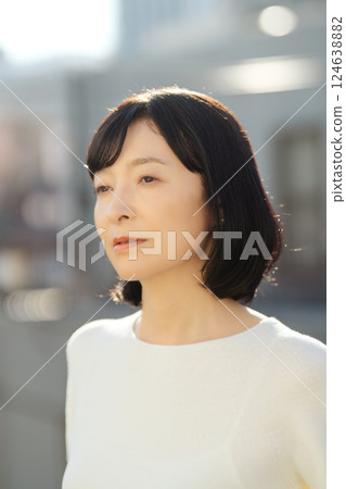 A middle-career woman enjoying the fresh air A middle-career woman enjoying the fresh air 124638882