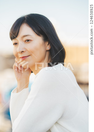 A middle-career woman enjoying the fresh air A middle-career woman enjoying the fresh air 124638925