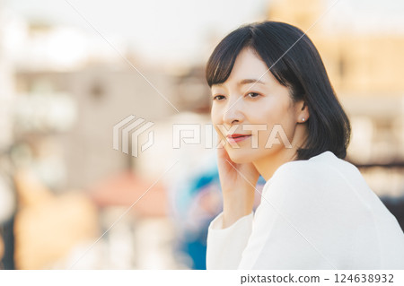 A middle-career woman enjoying the fresh air 124638932