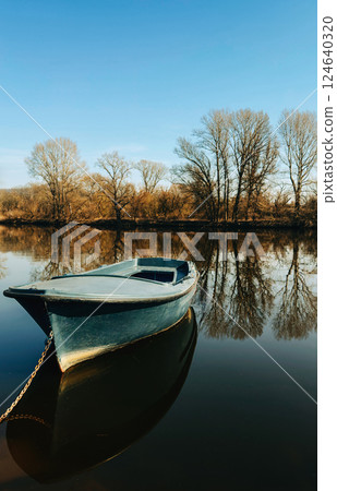 A lone blue boat floating on a 124640320