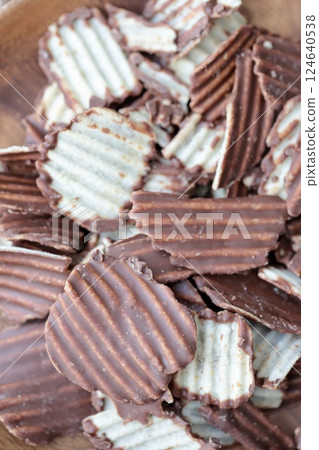 Jagged cut chocolate potato chips Jagged cut chocolate potato chips 124640538
