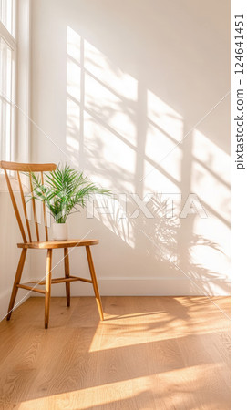 wooden chair with potted plant in sunlit Scandinavian style room wooden chair with potted plant in sunlit Scandinavian style room 124641451