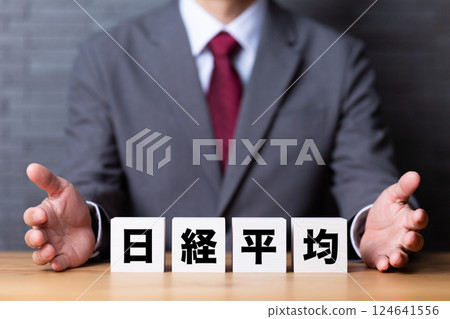 日經平均指數的一塊區域和一位身著西裝的中年男性商人 124641556