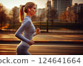 A young woman jogging through an urban at sunrise environment. Ai generated. 124641664