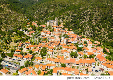 Aerial view of Eus village on hill with ancient church, France Aerial view of Eus village on hill with ancient church, France 124641893
