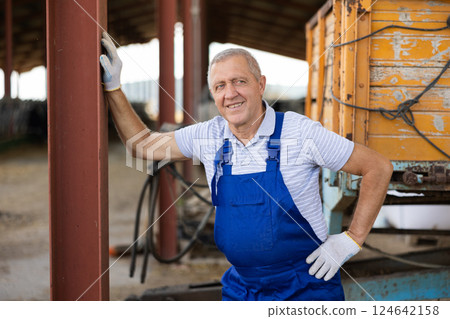 Elderly male worker posing on farm Elderly male worker posing on farm 124642158