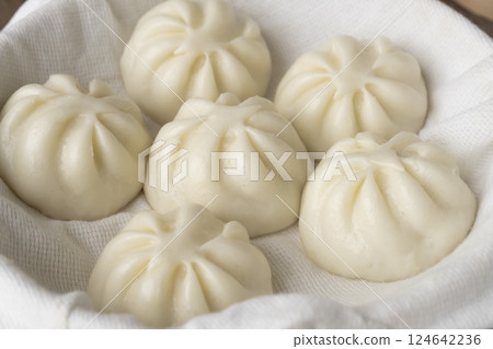 Steaming steamed meat buns in a bamboo steamer Steaming steamed meat buns in a bamboo steamer 124642236