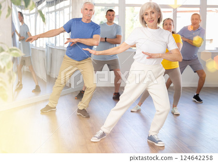 Elderly woman dances modern dances in group 124642258
