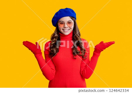 Trendy portrait of fall style. Girl in autumn jumper isolated on yellow. Teen girl wear sunglasses. Autumn fashion girl. Trendy and stylish teenager girl presenting product. Fall style for teen 124642334