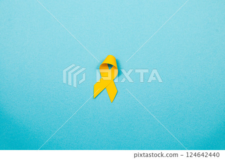 Support for cancer awareness through the yellow ribbon symbol 124642440